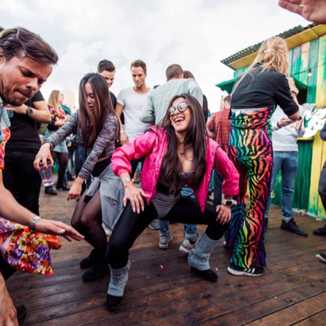 People dancing low in matching outfits